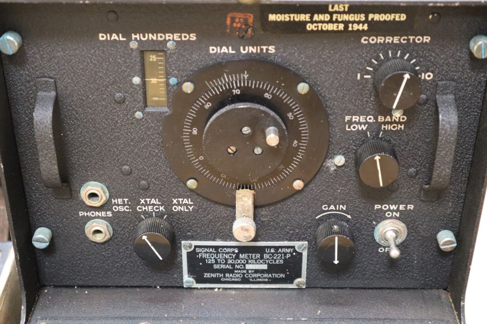 A collection of vintage military equipment, including a WWII British Tank Telescope Sight No. 33 MK III,
